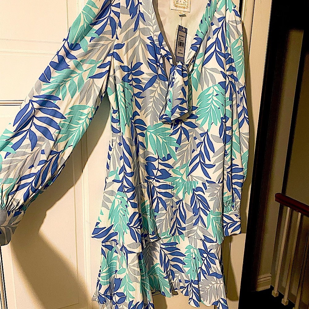 Length 34”,bold palm blue skirt, Ruffle hem skirt, gold buttons, & slight puff.